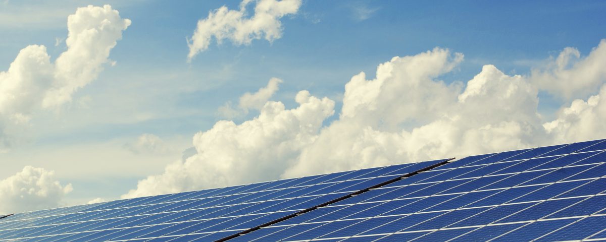 solar panels and blue sky with clouds